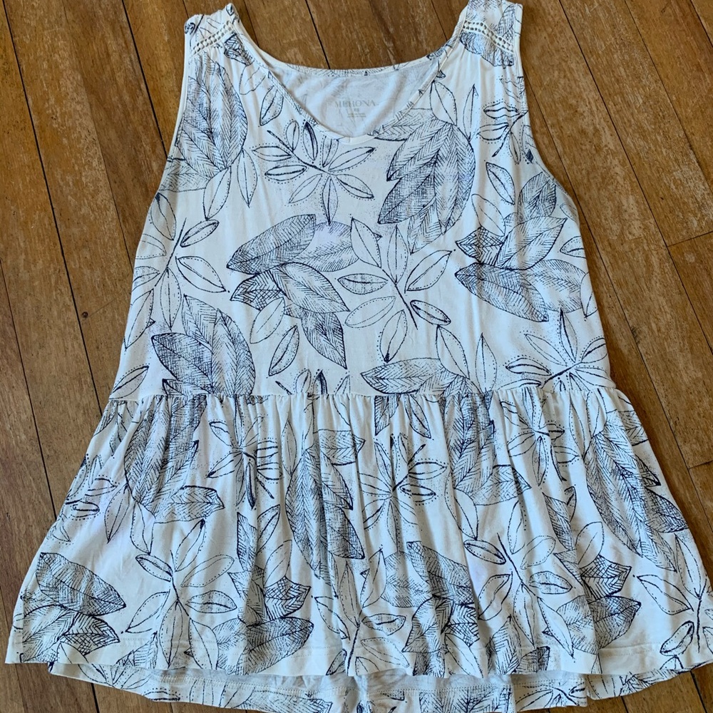 White/navy floral print loose-fit peplum tank.